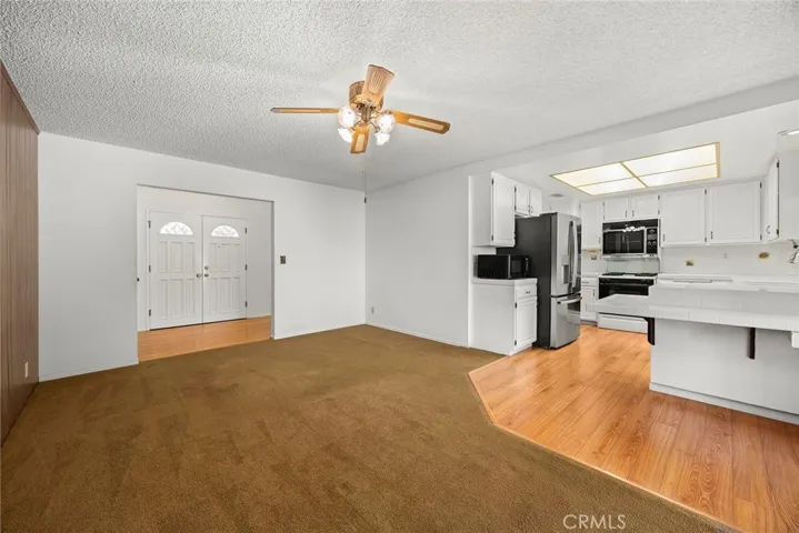 Central living space off of entry and looking into kitchen