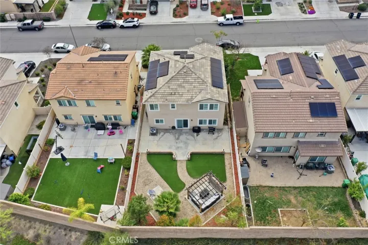 Aerial view of rear of home and backyard
