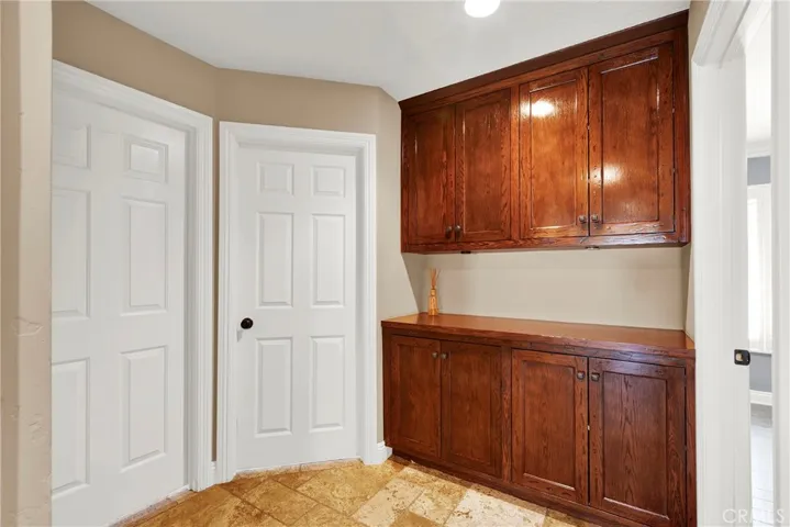 Hallway Cabinets between bedrooms. Custom Panel Doors and Hardware. Travertine Flooring.