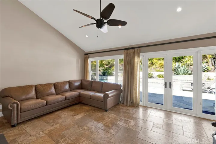 Additional view of family room with vaulted ceiling, recessed lighting, center ceiling fan and gorgeous backyard views.