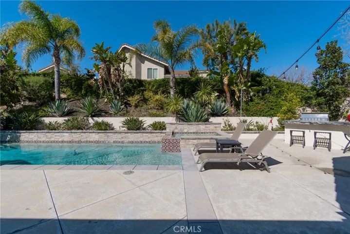 Backyard private update saltwater pool spa, gardens and Bar B Q Island as seen from family room and kitchen.