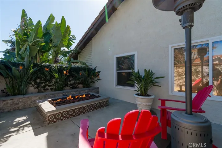 Additional private area in backyard outside kitchen with gas fire ring. Lovely area for quiet time reading a book or enjoying a glass of wine.