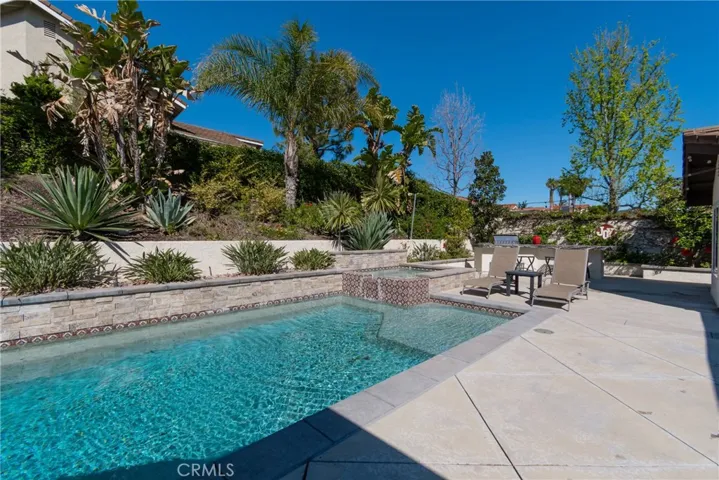 Additional view of your private custom updated salt water pool & spa and easy care gardens.