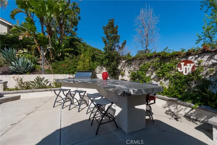 Custom backyard Island with built-in Bar B Q and storage. Looking out kitchen windows