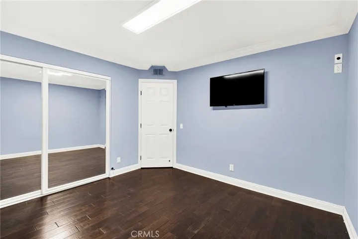 Bedroom 3. Crown Molding. Custom Wood Shutters over Milgard Windows. Center Lighting. Custom Wood Flooring. Mirrored Closet Doors. TV Custom Mounted walls fished.