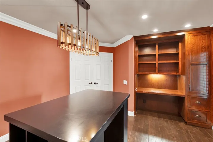 Bedroom 4 is currently set up for an office, with Custom Built-in Desk and Storage, Custom Center Desk and Cubby is NOT attached to floor and is movable, Custom Dual Panel Doors and Hardware, Custom Crown Molding, Custom Center Light fixture and recessed Lighting and Custom Wood Flooring.