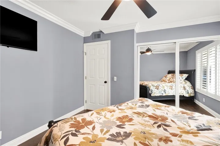 Bedroom 2. Crown Molding. Custom Panel Door and hardware. Mirrored Closest Doors. Custom Wood Shutters and Milgard Windows, Ceiling Fan and Light. Custom Wood Flooring. Custom TV Mount with walls fished wiring.
