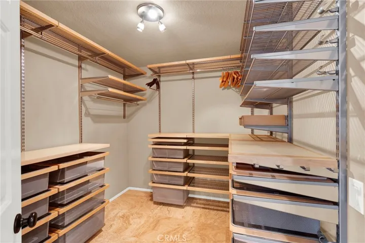 Primary Suite Custom Walk=In Closet with Custom Organizer and lighting.