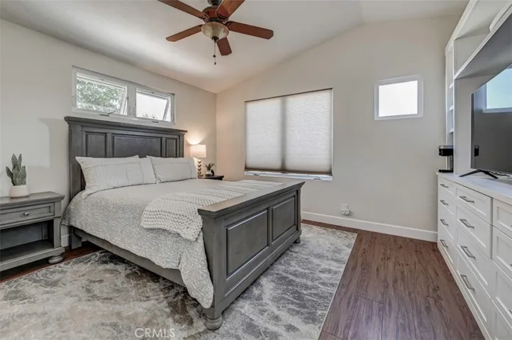 Primary Bedroom- Light and Bright with lots of windows, vaulted ceilings, ceiling fan and beautiful Built-ins! Coffee and the morning news! Late night TV! You won't want to leave this beautiful bedroom!