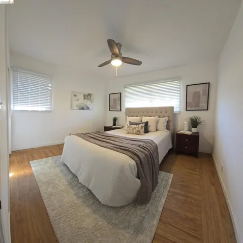 Bedroom with hardwood / wood-style flooring and ceiling fan
