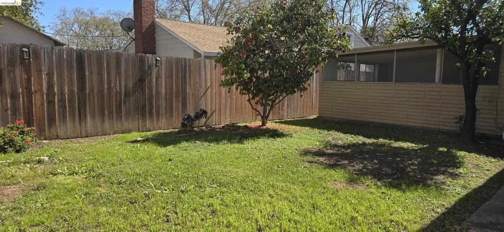 Fenced yard with a sunroom