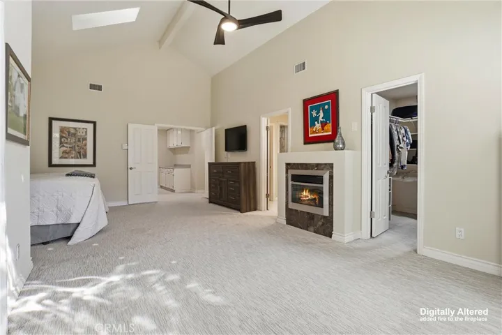 Primary suite with fireplace and walk-in closet.