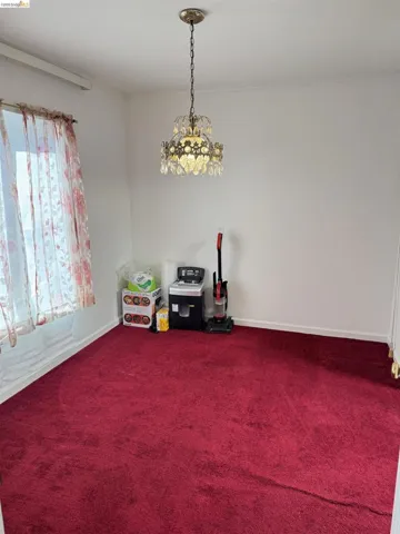 Rec room with dark colored carpet and baseboards