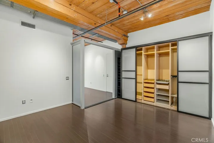 Bedroom with custom made closets and sliding door