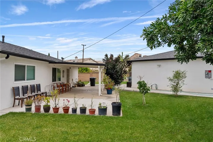Right side of the back yard lawn. view of Main house on the left and ADU on the right