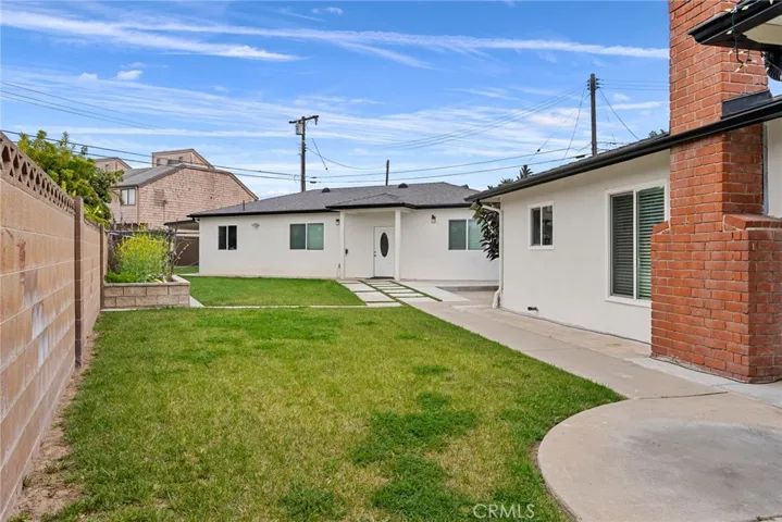 Left side back yard lawn. front house on the right. ADU on the left end.