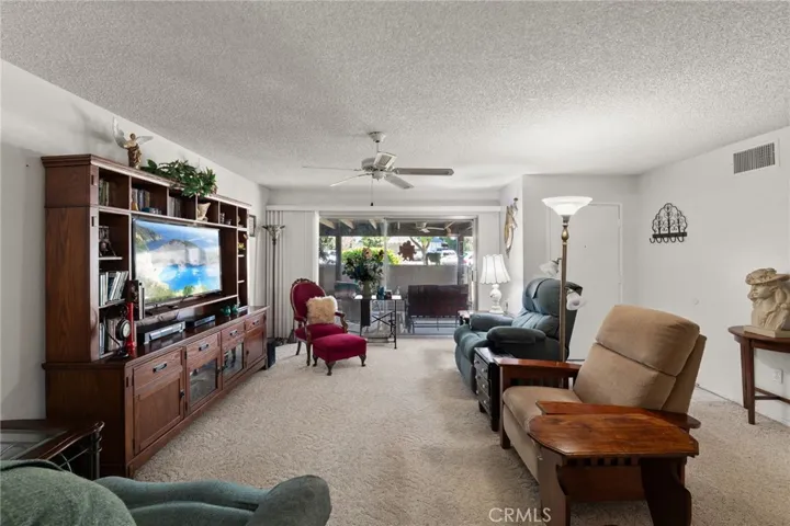 This great room is the perfect layout to enjoy your favorite programs or enjoy a breeze from the courtyard!