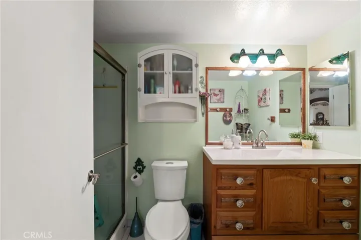 This ensuite bathroom off the primary bedroom has been remodeled to feature a walk in shower and new countertop. It also has been recently painted!