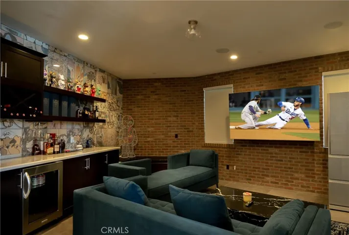 First floor media room with wet bar and wine fridge.