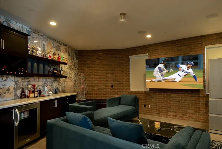 First floor media room with wet bar and wine fridge.