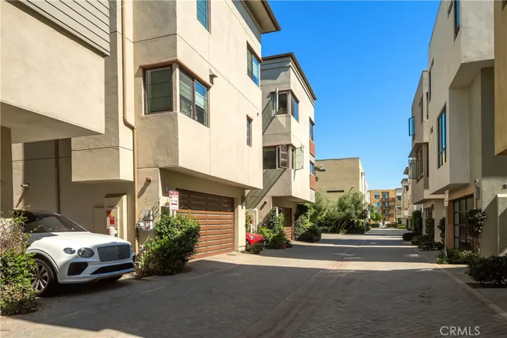 Two car garage entry with extra parking space and a Tesla charger.