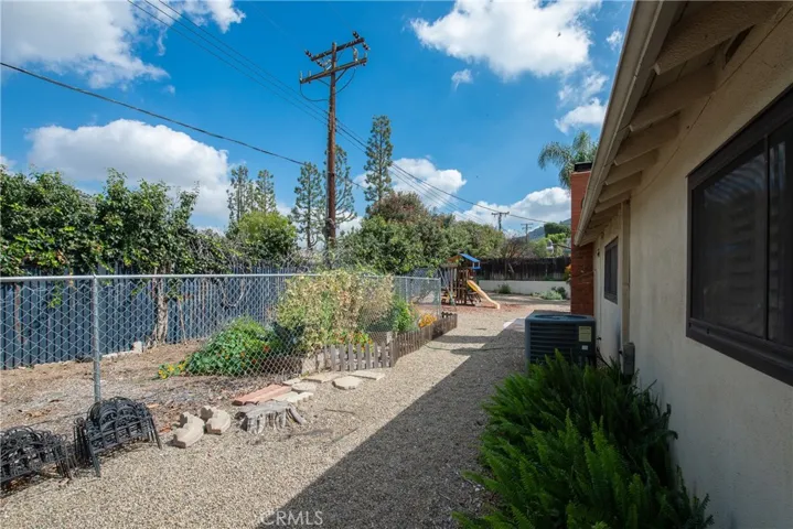 The fenced area to the left is the ideal spot for a vegetable garden.