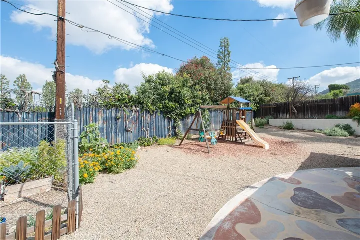 The large backyard has an included playset.
