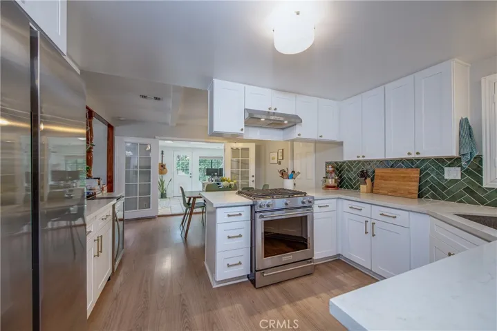 The remodeled kitchen has white shaker cabinets with gold hardware that is absolutely goregous! Any chef will love the stainless steel appliances including the range with an electric oven and 5-burner gas cooktop.