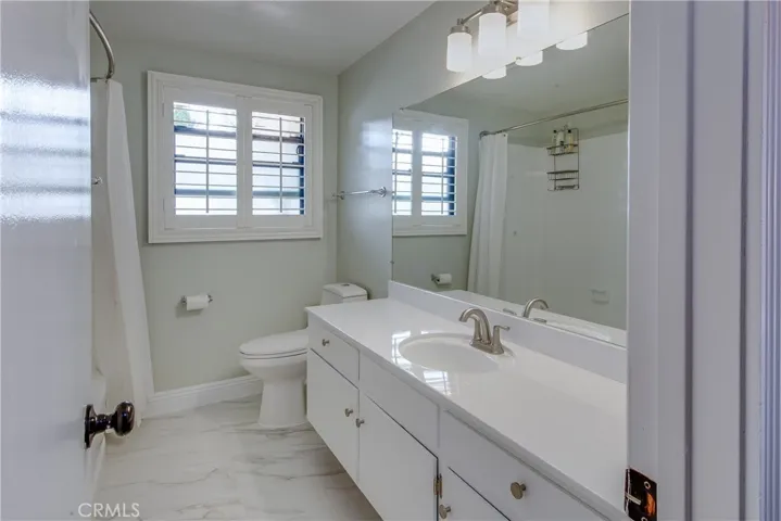 The hallway bathroom is spotless and includes a newly refinished bathtub/shower combination, vanity and sink along with NEW tile flooring.