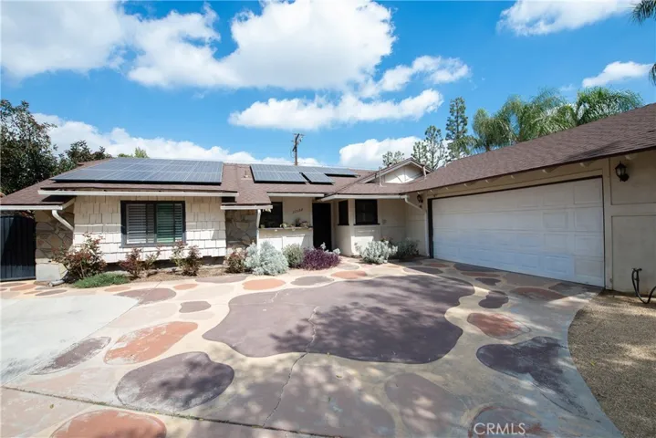There is plenty of space to park in the wide driveway and two car garage that is brightly lit with a skylight and large window.