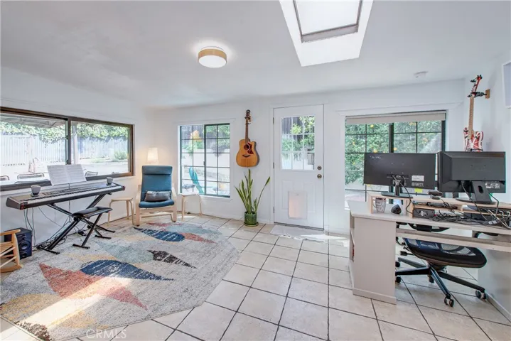 The bonus room is next to the dining area. It is bright with the large windows and skylight and is the ideal spot for a playroom, game room, office or hobby room.