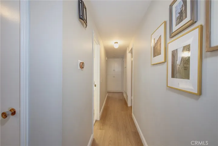 Down the hallway you will find the hall bath to the left, the primary bedroom further down the hall to the left and bedrooms two and three to the right.