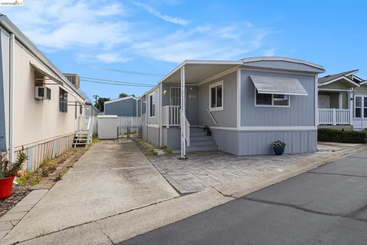 Manufactured / mobile home featuring a gate and driveway