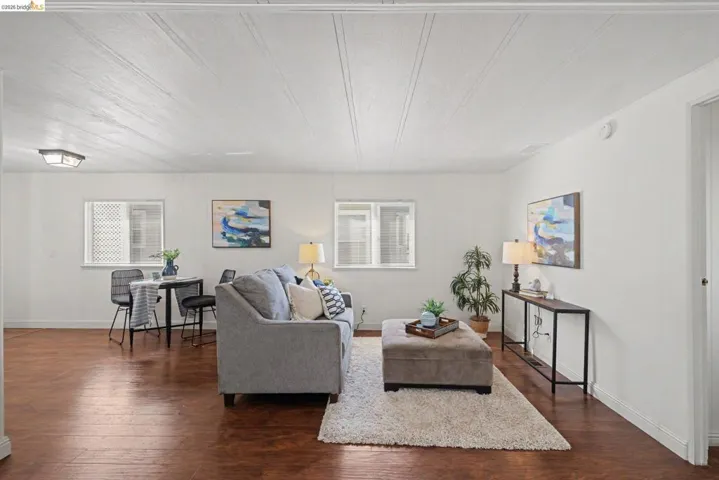 Living area with dark wood-type flooring