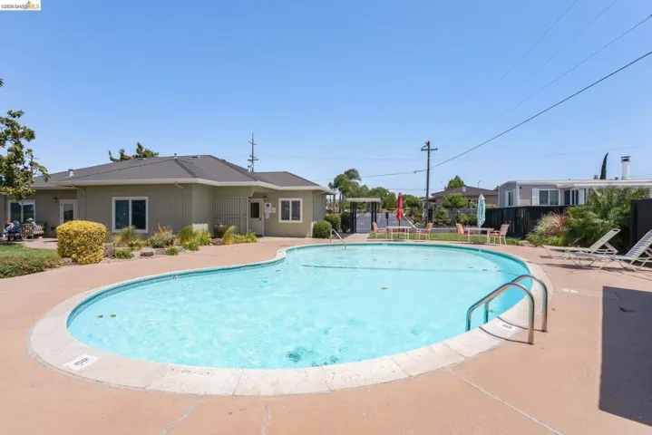 Community pool featuring a patio area