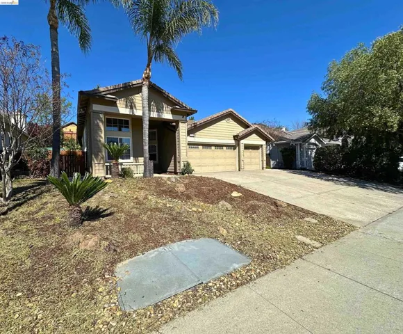 Ranch-style home featuring a garage and concrete driveway