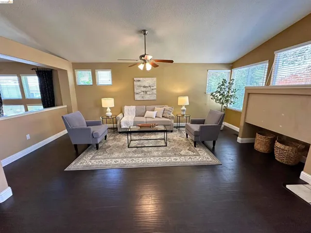 Living room with a ceiling fan and wood finished floors