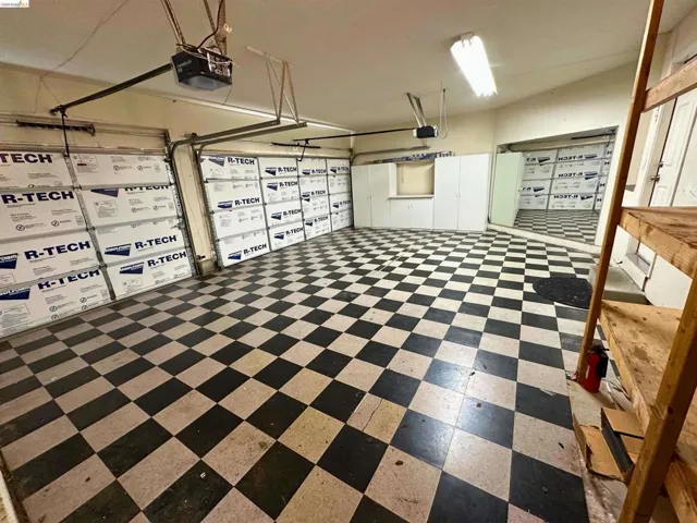 Garage featuring a garage door opener