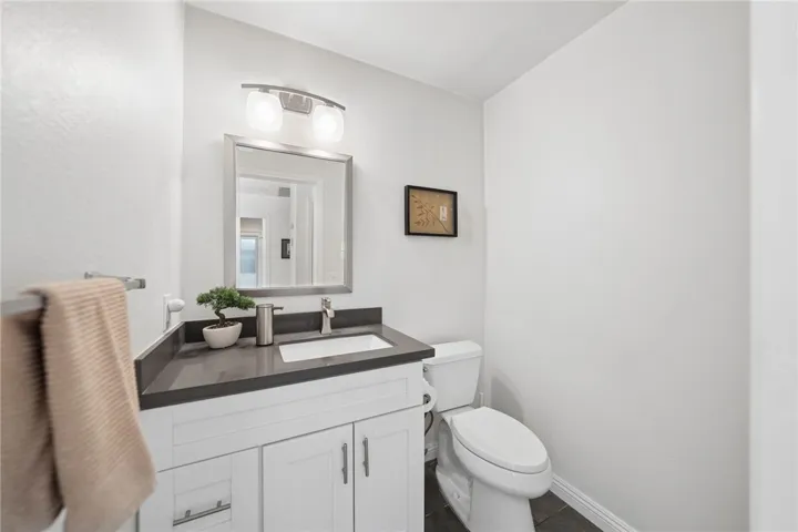 Quartz countertop and clean contemporary finishes create a fresh, polished look, while the simple, functional layout adds convenience for guests.