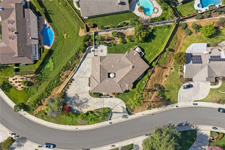 Straight-down aerial perspective emphasizes the property’s generous lot size, long driveway, and usable outdoor areas.