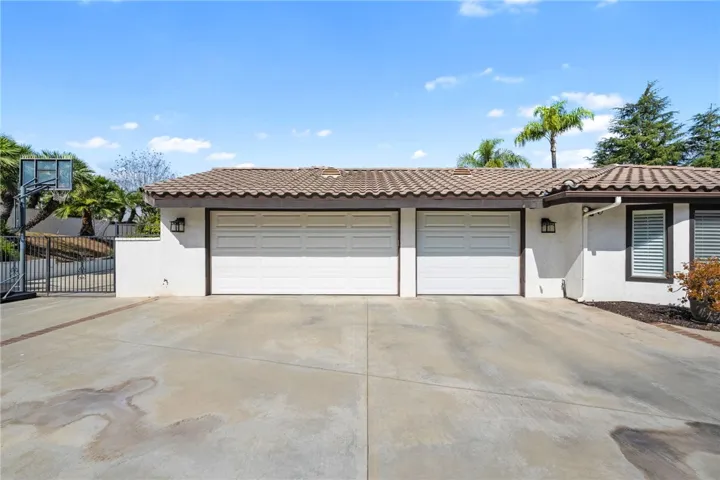 Spacious garage frontage with side gate access and additional paved area adds convenience and flexibility for everyday use.