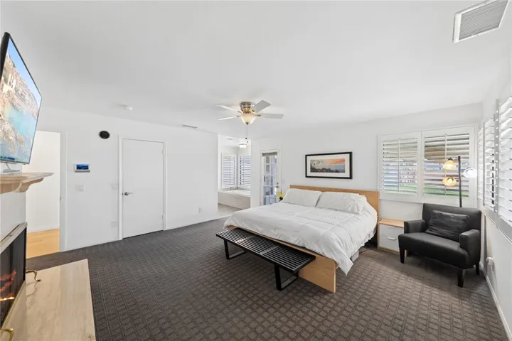 Bright and expansive primary suite with generous floor space, multiple windows, and a soft neutral palette. The open layout offers flexibility for both sleeping and lounge furnishings.