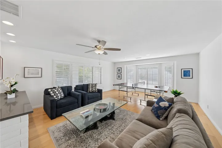 Expansive living area offers generous seating space, wide windows with plantation shutters, and flexible room for lounging or recreation.