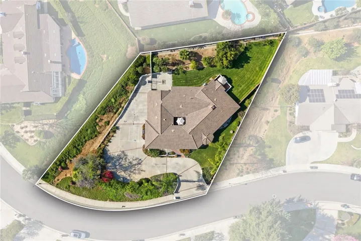 Overhead lot image with boundary overlay clearly showcases the home’s footprint, yard space, driveway layout, and prominent corner-lot position.