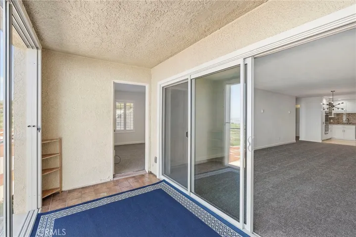 Primary bedroom has direct access to balcony/sunroom.
