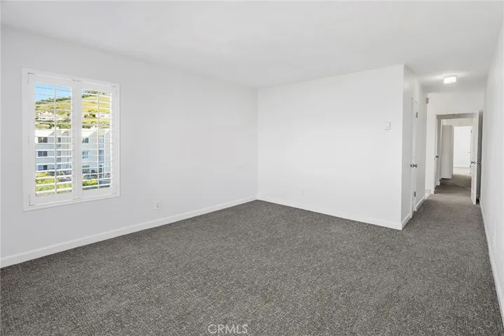 Primary bedroom has windows and two sides and access to balcony.