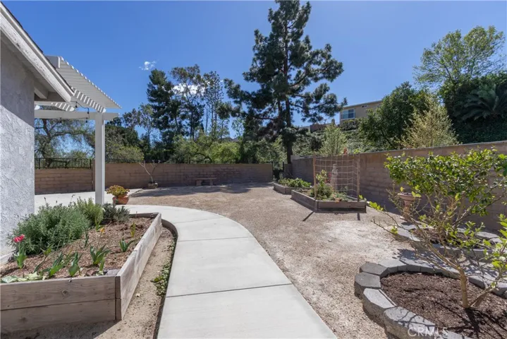 Side yard grow box and fruit trees.