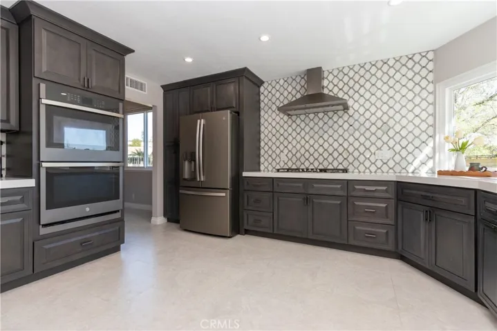 Double oven and large cooktop with hood.