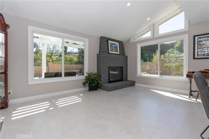 Large windows and another cozy fireplace in the family room.
