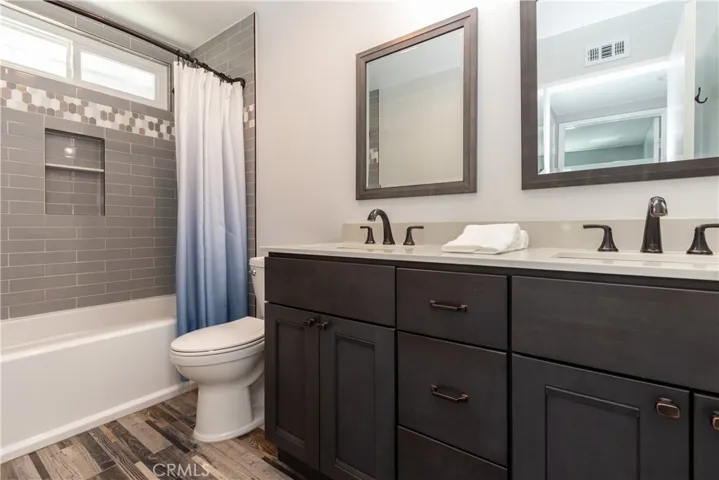 Upstairs hall bath with dual vanity and shower/tub.